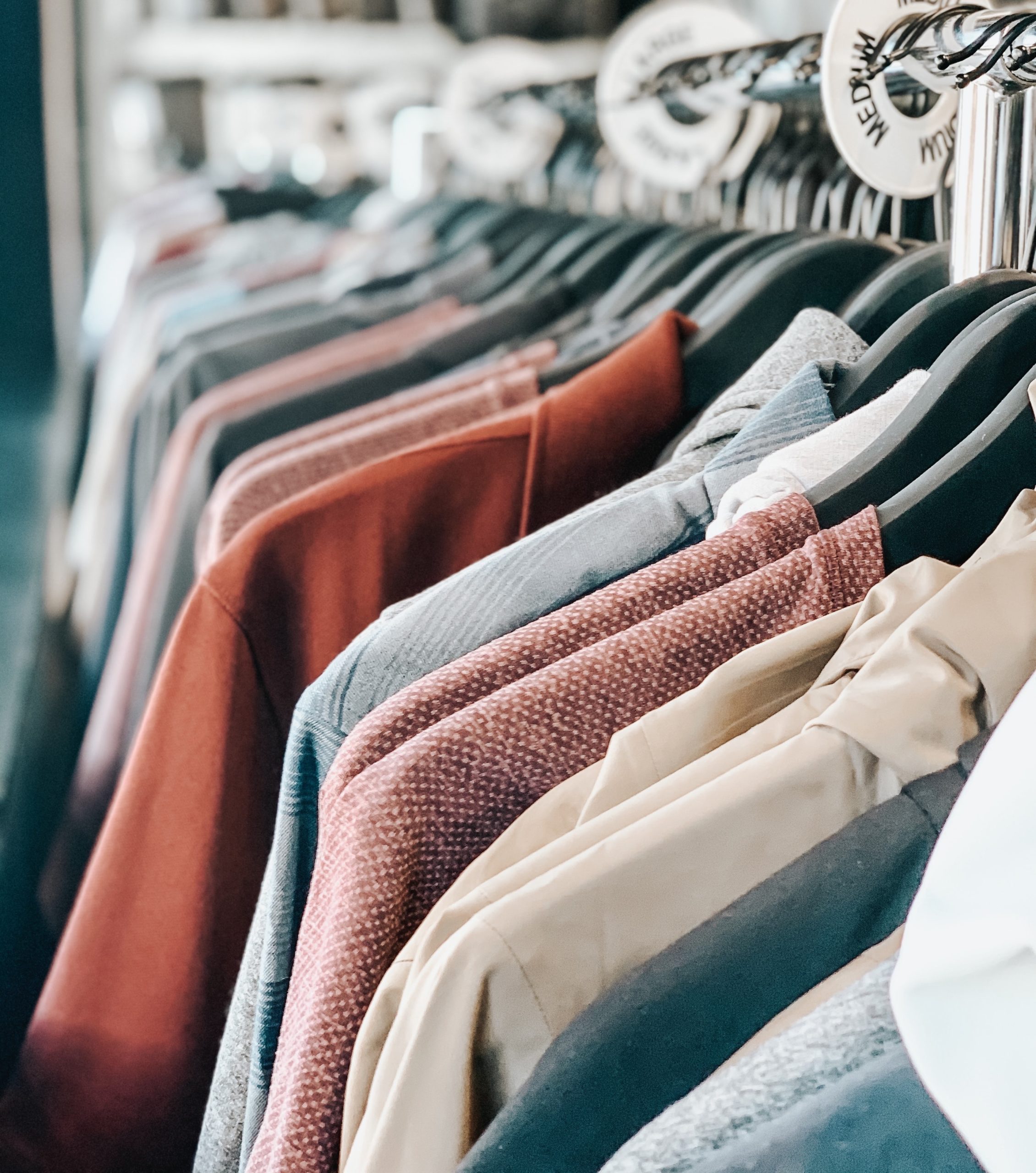 Thrift store clothing rack with colorful jackets
